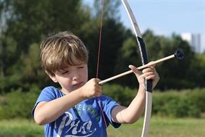 Boy loading practice arrow on bow